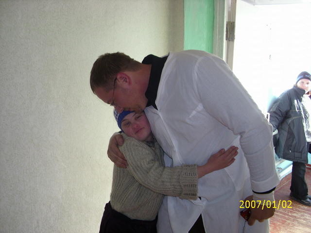 Sam gets a hugs from a resident.