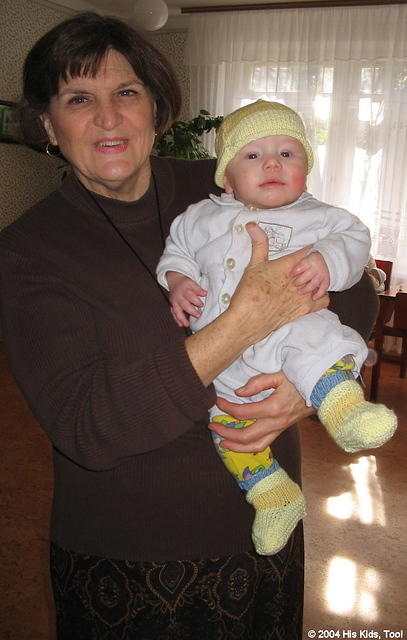 Lynn enjoys holding the babies!  They are all adorned in their new outfits.