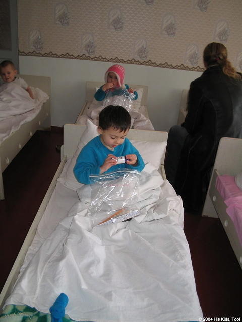 This little one examines the shampoo from her personal care bag.