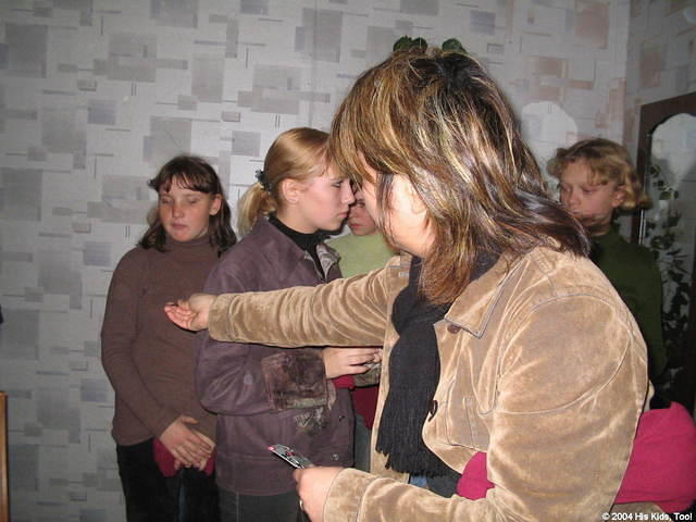 Volunteer Fami, passes out stockings, and hair clips.