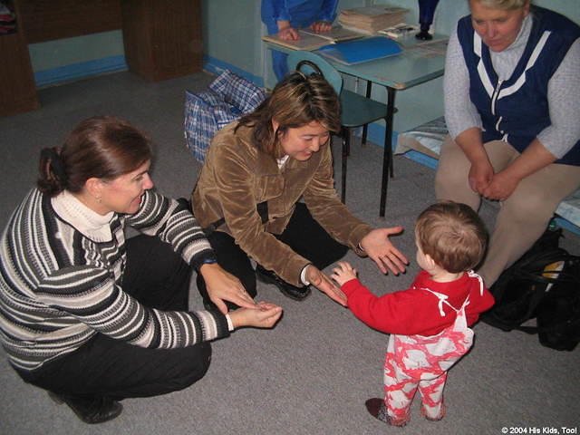 Fami tries encourages this boy to walk to her.