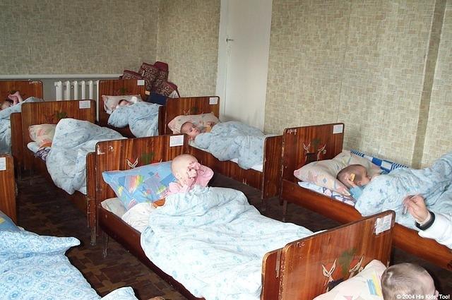 The room is lined with beds ALL with children in them, though some you can't see the children.  You can hear moaning from under