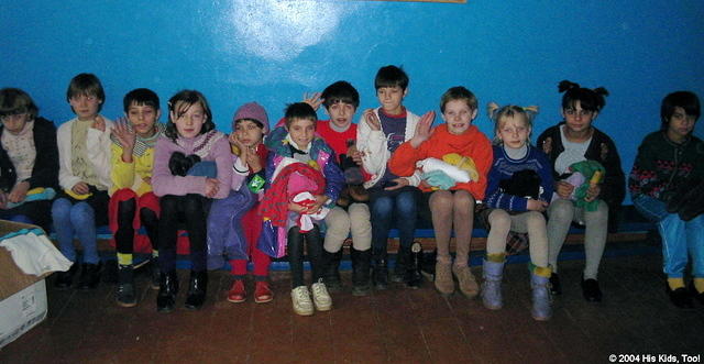 This facility is presently home to 50 orphans.  Here the younger girls await to get clothing.  The director and assistant help w