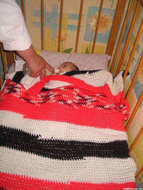 Keeping warm in his new blanket, thank you Frieda H.