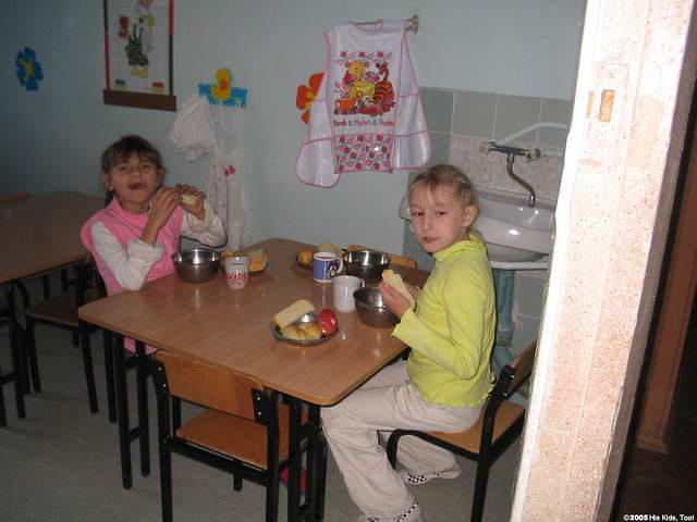 Two of the older children enjoying lunch.