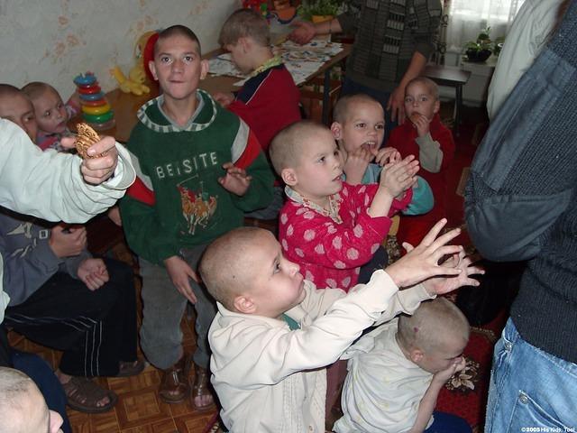 Children anxiously await cookies and bananas.