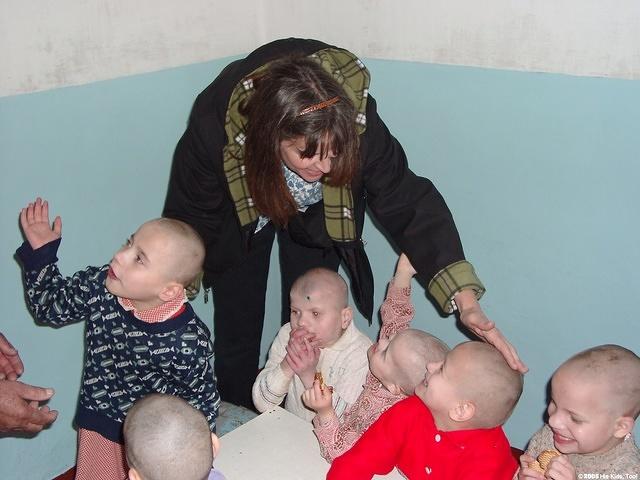 Peggy makes a point  of touching as many children as possible.