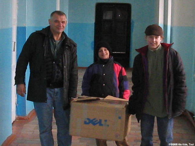 Yuri and resident, Sasha  and Nastaya help carry in boxes of clothes.
