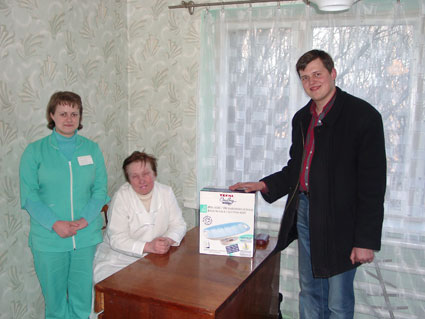 His Kids, Too! board member, Denis, presents the Artum Orphan Hospital with a much needed and requested baby scales.  They were