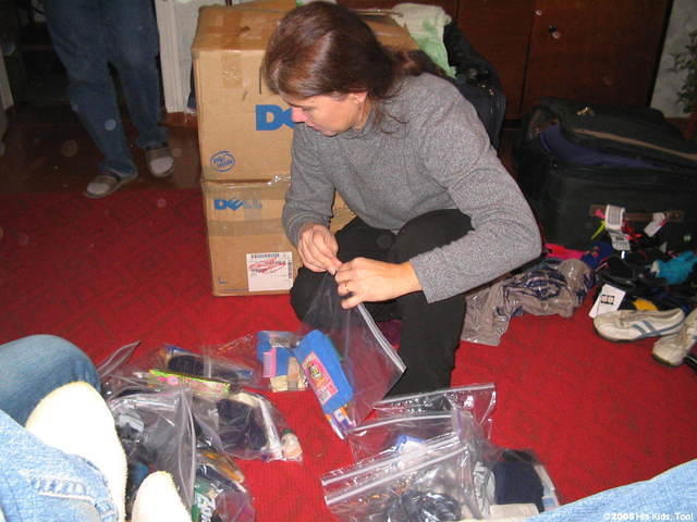 Teresa sorts, and puts together personal care bags.