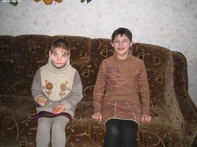These young girls were so proud of the new sofa in the T.V. room.