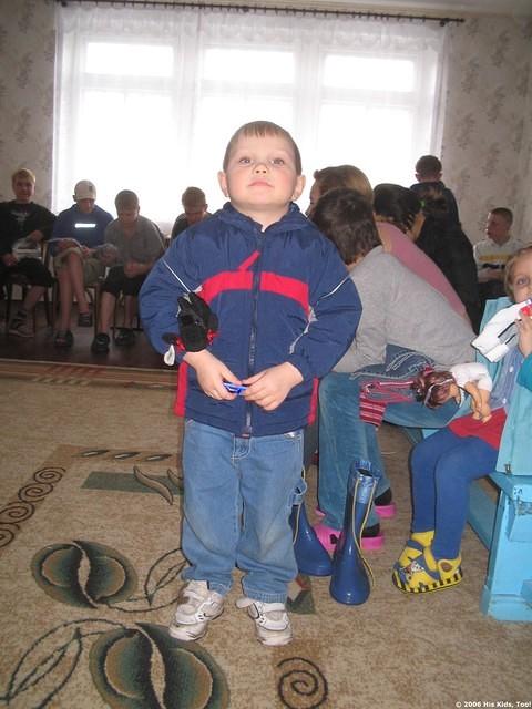 This boy was happy with his new clothes and coat.