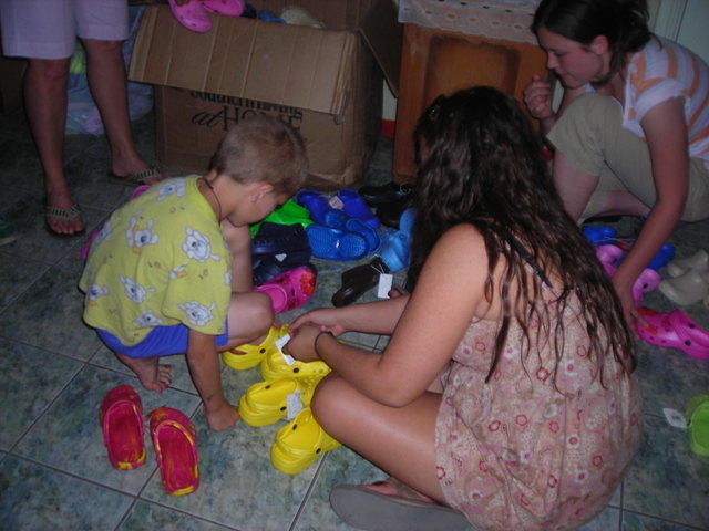 Lydia assists with finding Crocs for kids.