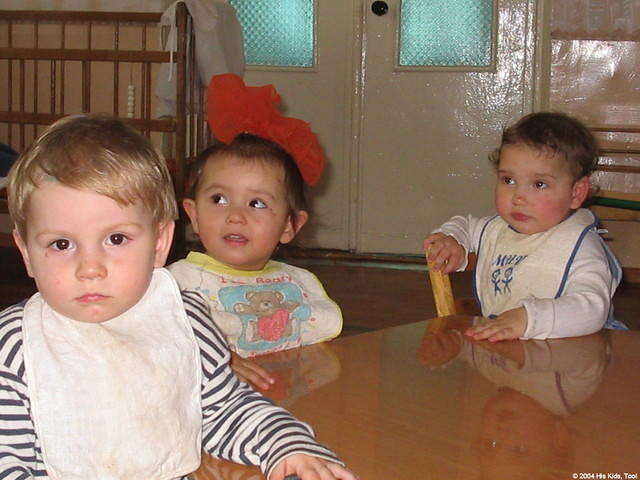 These older children wait for their evening meal.