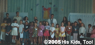 Ms. Mae, Danny, and Haley's class  sing to the crowd of 200+.