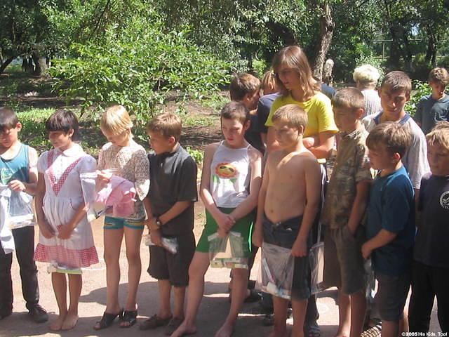Children patiently wait their turn for choosing garments.