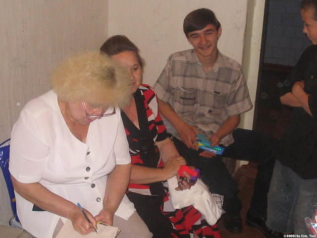 As children receive new clothing, staff member writes down each item for the inventory.