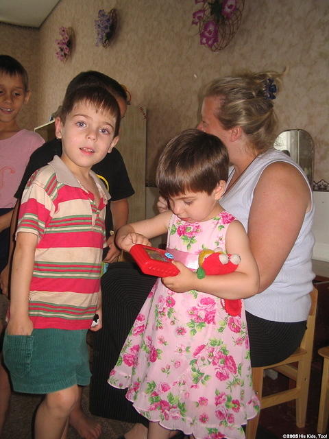 The children eagerly open their gifts.