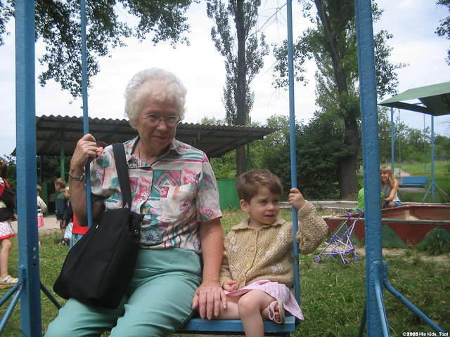Mae L. of Florida, enjoys swinging with this little boy.