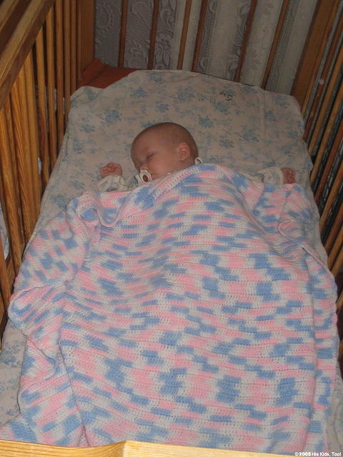 This baby is all snug in it's new blanket.
