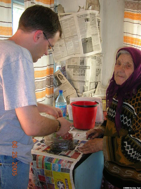 The lady offered Dave some fruit.
