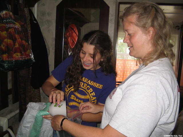 Kristy and Haley seperate sugar into ziplock bags.