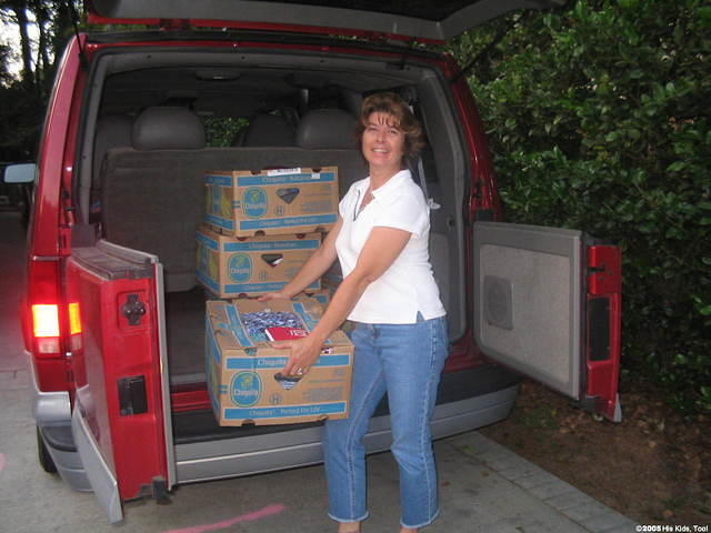 Volunteer Nancy S. helps unload boxes.