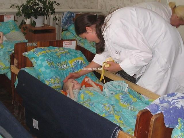 Masha tenderly feeds this boy.