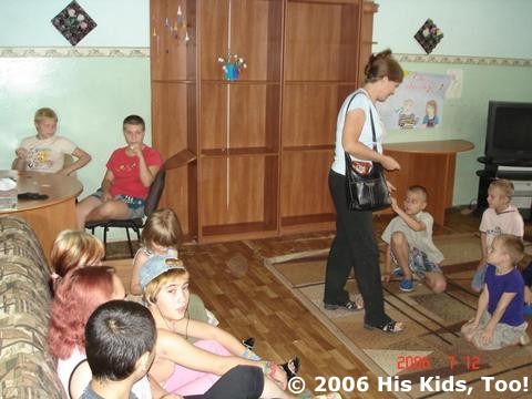 Teresa passes out candies to the kids.