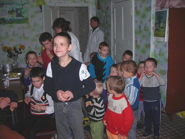 These boys and teens enjoy the snacks.