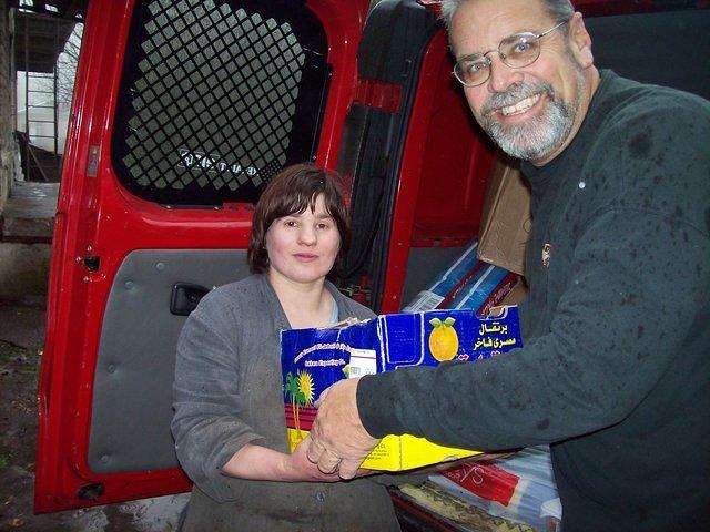Many of the children insist on helping carry the aid for their facility.