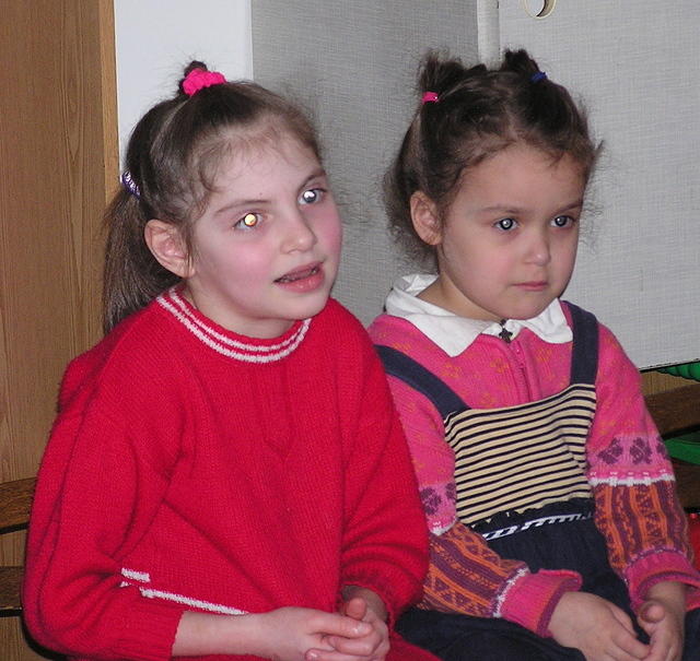 These sweet girls enjoy the singing.
