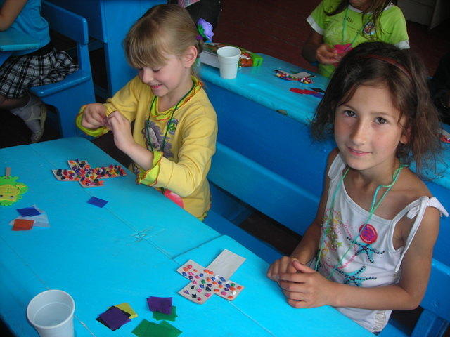 While these young ladies use tissue paper to decorate their crosses.