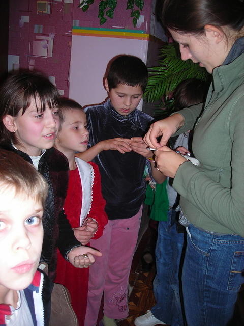 Anya passes out hair clips to the older girls.