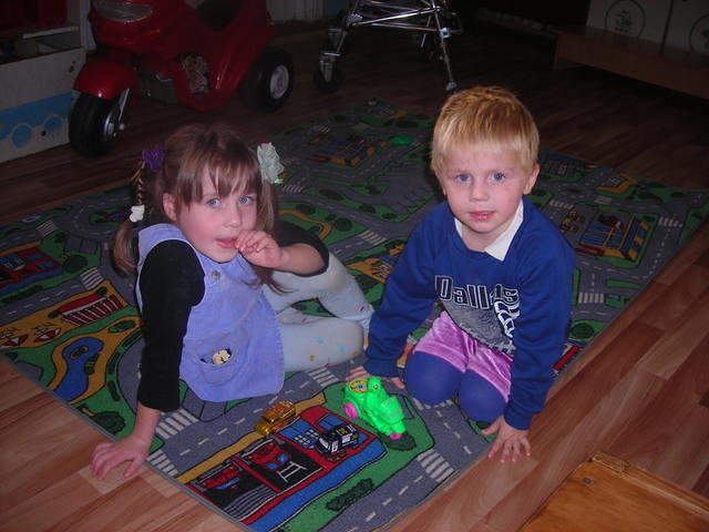 These 2 boys like playing 'cars'.