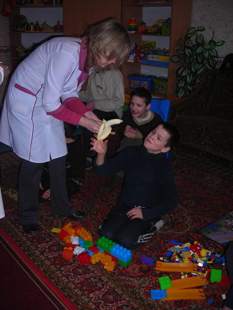 Staff assist with banana distribution.