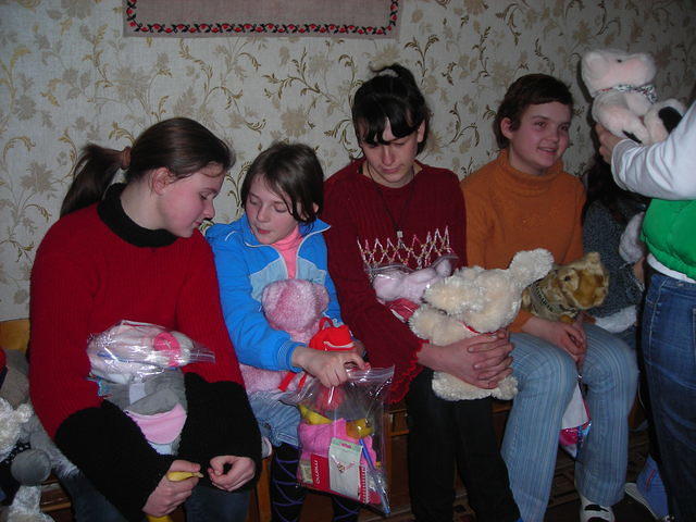 The girls look over the items in the personal care bags.