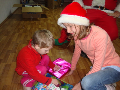 Alla assists this little boy with his box.