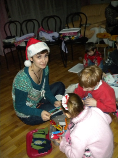 Natalia helps the kids with their boxes.
