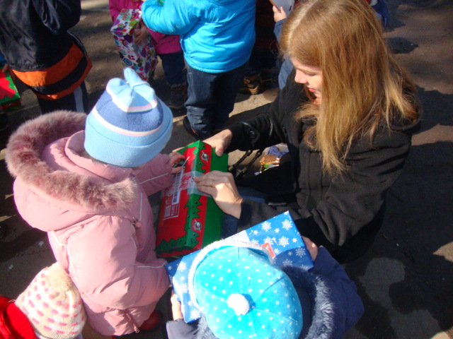 Teresa helps this little one open her box.