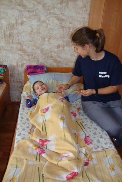 Susanna feeding a little boy.
