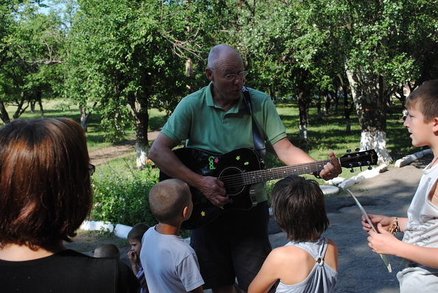 Ted plays a song for the kids