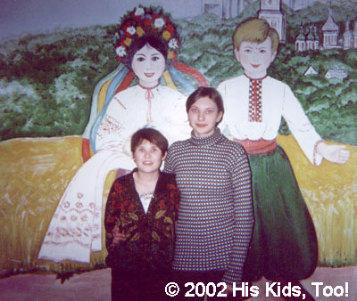 Two orphans at the local internot pose in front of this beautiful Ukrainian painting.