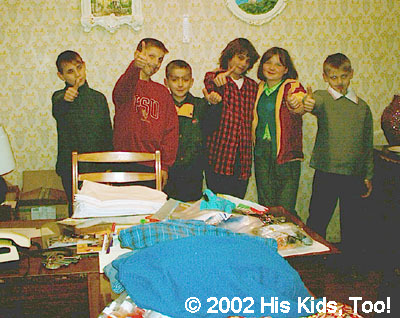 The kids pose, still in their make up from their performance, in some of the new clothing, donated items fill the room!