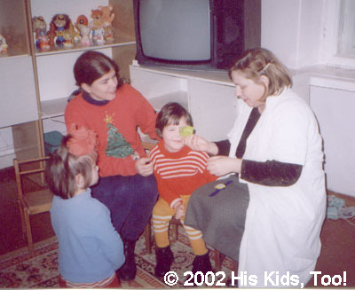 His Kids, Too! director is helping Yulia choose a toy.