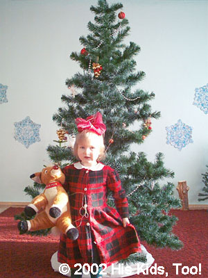 Alla in front of the 'Yolka,' Christmas tree. She loves that reindeer!