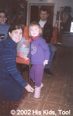 Getting dressed for leaving the orphanage.  Special boots made from fabric from the May Kay jet!!