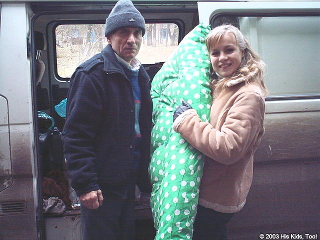 His Kids, Too! volunteer, Dima and Christina unload new mattresses for the cribs.