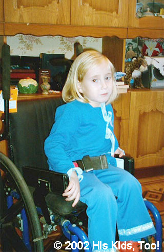 Though camera shy, Masha was very happy for her new wheelchair. She is 5 and paralyzed from the waist down. His Kids, Too! gave