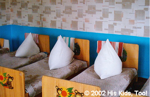This room has received some repairs of new wall paper, with matching blankets, and flooring. The children are very pleased with